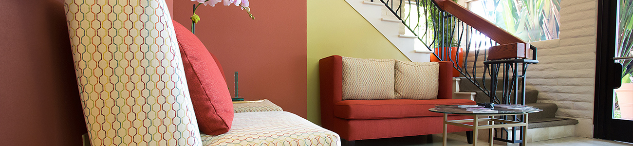 A cozy living room featuring a couch, a chair, and a table arranged for comfort and relaxation.